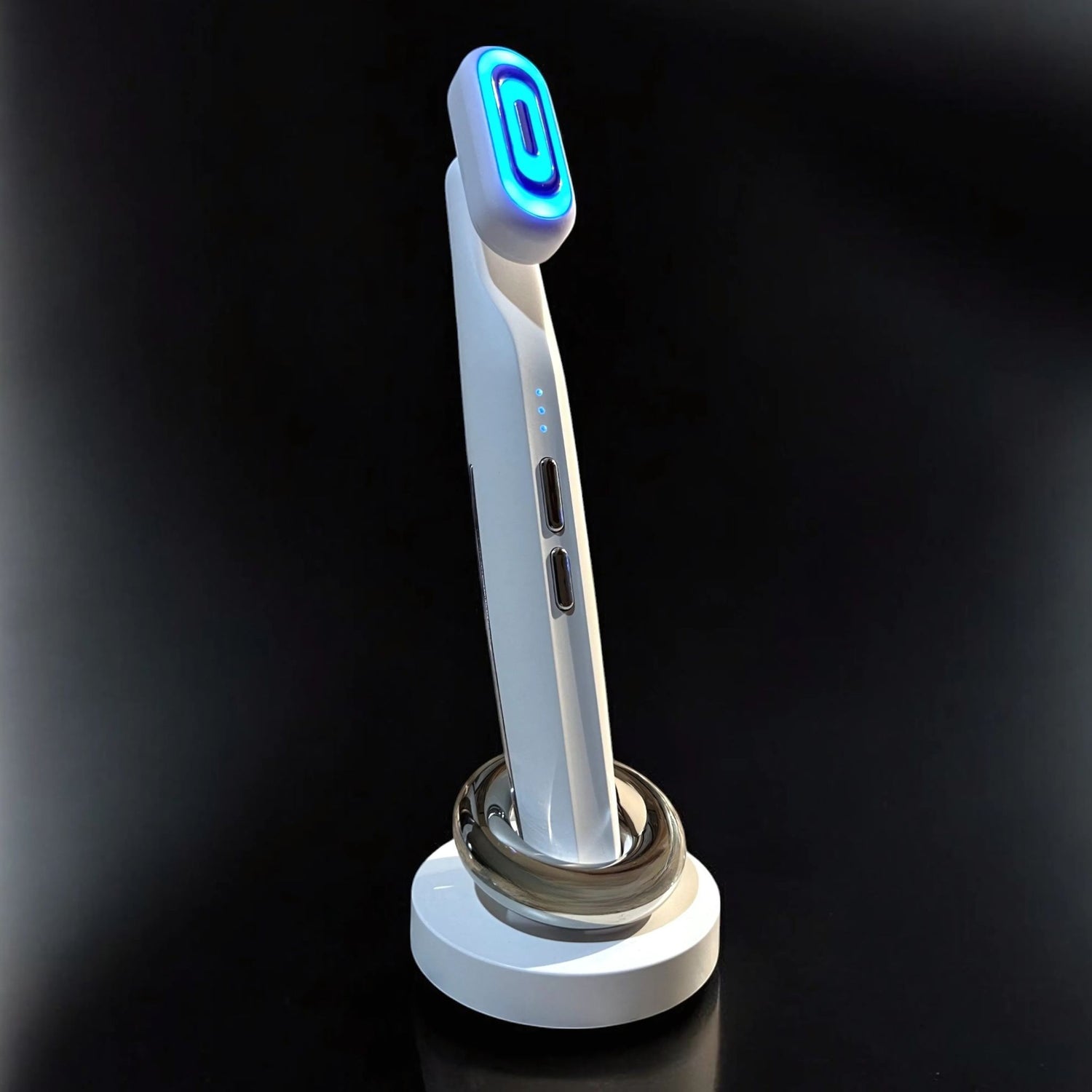 EMS micro-current blue light therapy wand standing in front of a dark backdrop.