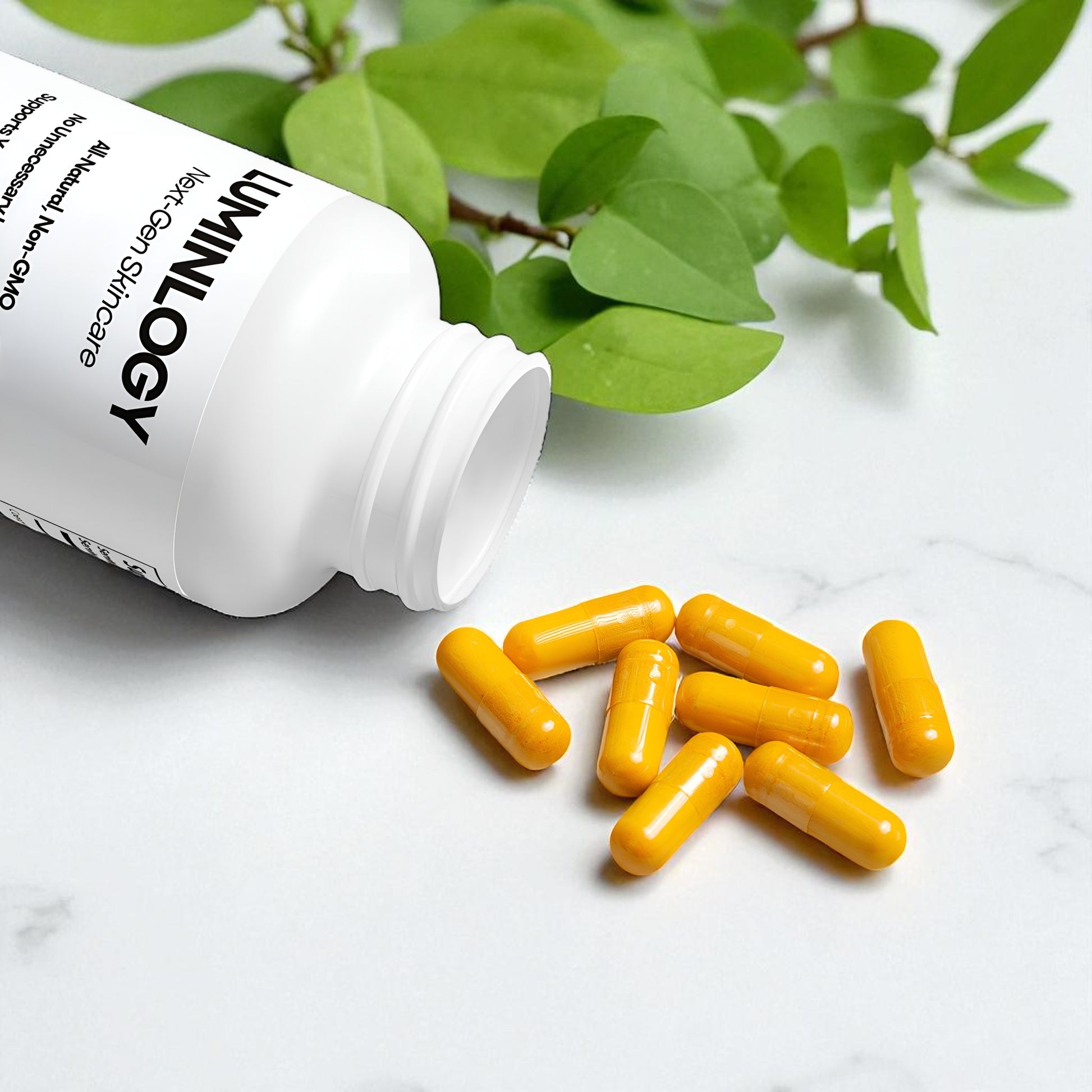 Yellow CoQ10 capsules spilling out of a white bottle labeled 'Luminology' on a light surface with green leaves in the back.