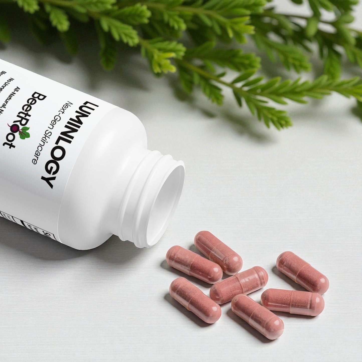 Beetroot supplement bottle with red capsules on a table with green nature leaves in the back.