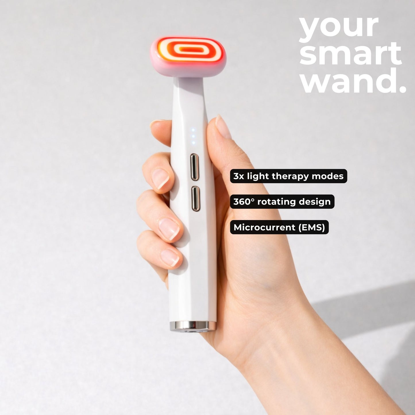 Hand holding a smart red light therapy face wand with the specs and modes labeled. 