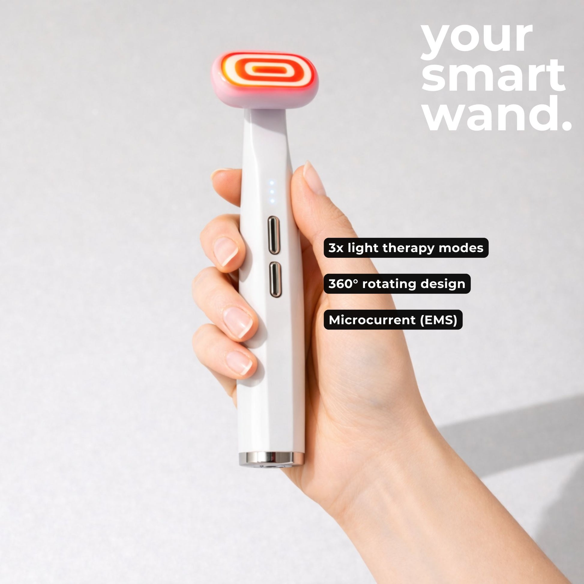 Hand holding a smart red light therapy face wand with the specs and modes labeled. 