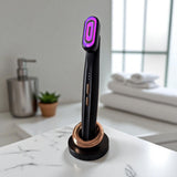 Purple light therapy device on a marble surface with a blurred bathroom background.