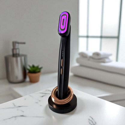 Purple light therapy device on a marble surface with a blurred bathroom background.