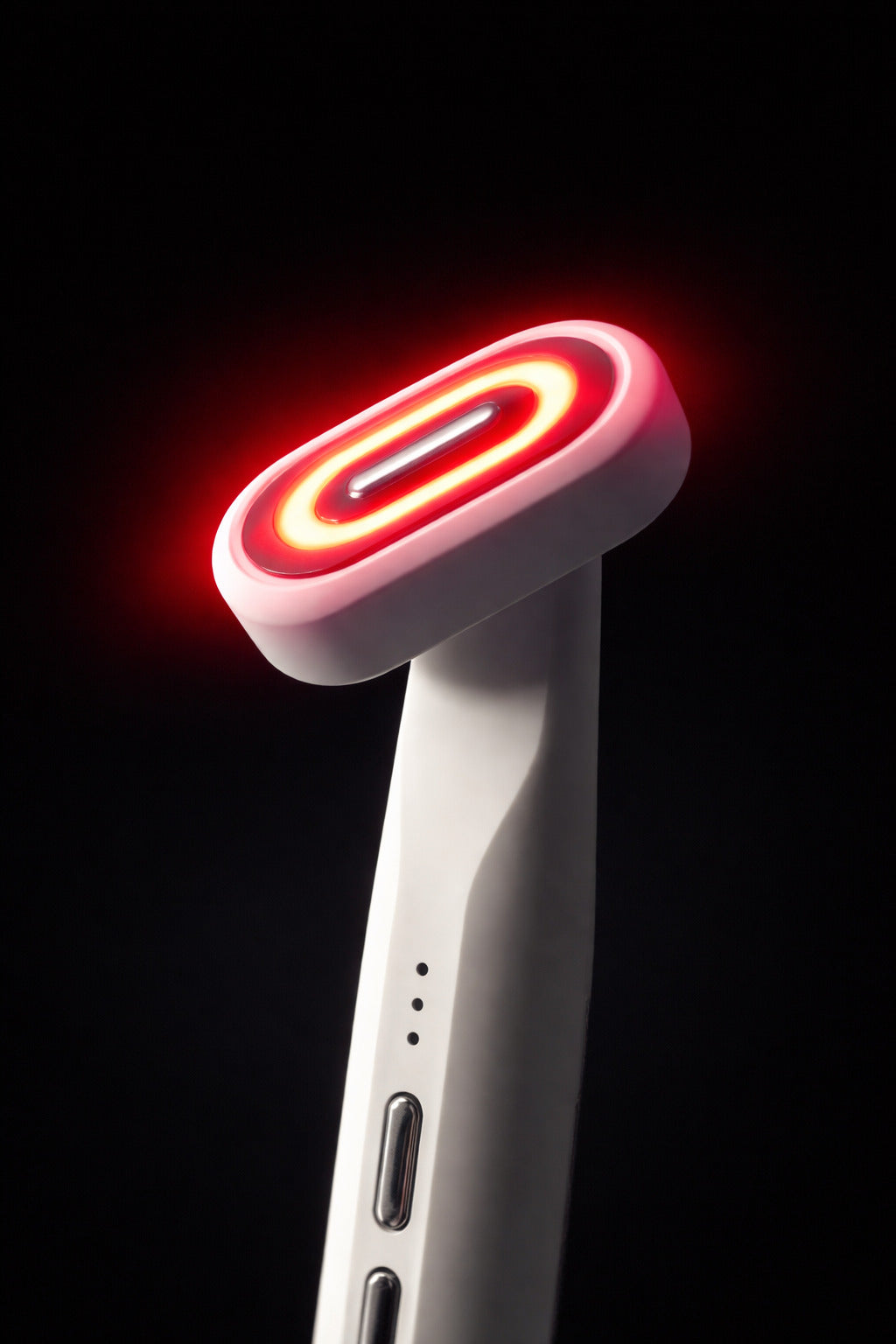 Red light therapy wand with a black background. 