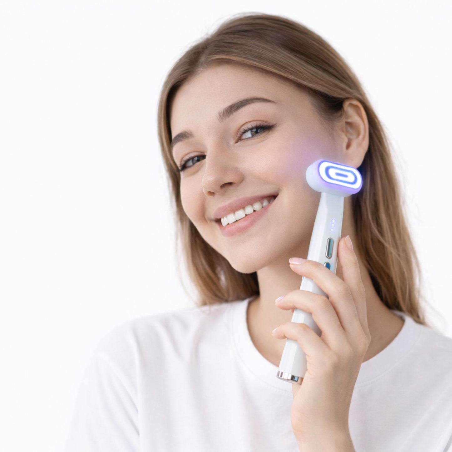 A young woman using the anti-aging purple light therapy wand on her face while smiling. 